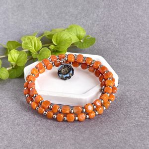Orange spiral glass boho bracelet for any size. New Year's gift for a woman. Minimalist orange jewelry with blue flower